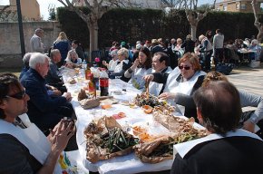 Uns 150 veïns dinen plegats en la calçotada popular del barri de la Llosa